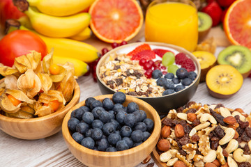 Group Fruits Breakfast mixed vegetables with salad bowl, nuts bowl, strawberry, banana, and pineapple, orange juice,  vitamin c in food  nature for health and diet in the top view on the wood table.