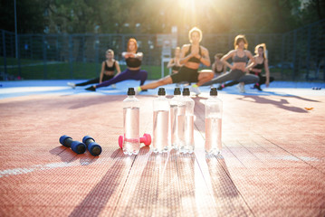 Fototapeta premium fitness, sport, training, gym and lifestyle concept - group of women with bottles of water in gym