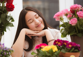 Woman Preparing to trim red and pink roses and beautiful flower arrangements in the home, flower arrangements with vase for gift-giving for Valentine's Day and Business in family on the on table