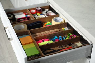 Different stationery in open desk drawer indoors