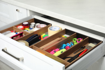 Different stationery in open desk drawer indoors