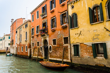 Venice canal with houses and boats. Typical transport and unique style of living.