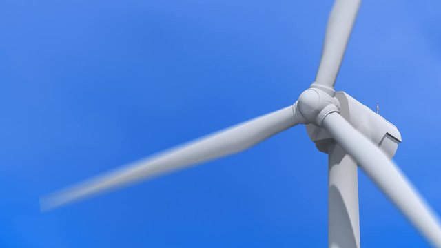 Wind turbine generator in operation w/ blue sky background. Green energy concept.