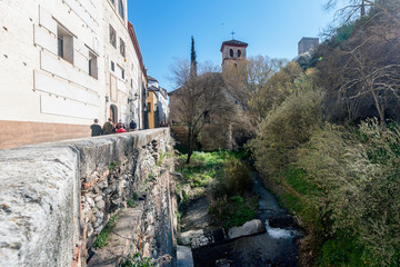 Fototapeta na wymiar The Carrera del Darro Street in Granada leads us along the Darro River to the Alhambra in Granada