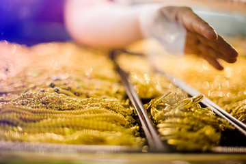 selective focus to hand is selecting gold jewelry, customers are buying gold jewelry.