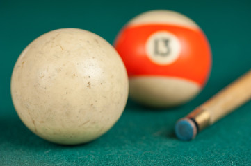 Billiards balls and cue on billiards table. Billiard sport concept.