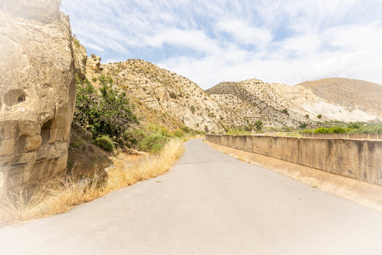 a paved road parallel to Nacimiento river next to Santa Cruz de Marchena, province of Almeria, Andalusia, Spain