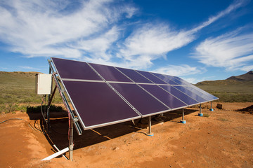 Close up wide angle view of photovoltaic solar panels on an off the grid electricity instalation on...