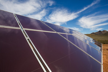 Close up wide angle view of photovoltaic solar panels on an off the grid electricity instalation on...