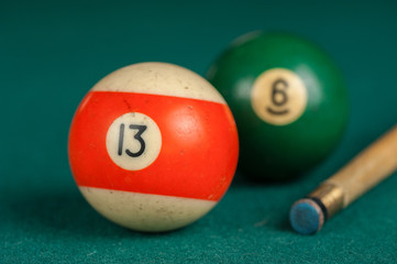 Billiards balls and cue on billiards table. Billiard sport concept.