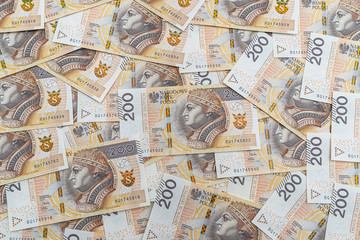 Background made from the front side of the Polish 200 PLN banknote, background for finance and economics.