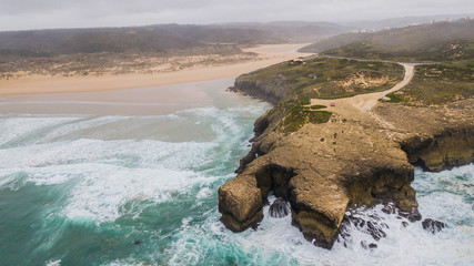 Aerial view Amoreira beach, in Aljezur, Portugal. Beautiful beach surrounded by cliffs
