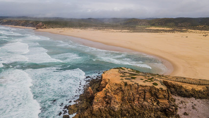 Aerial view of Bordeira beach, in Aljezur, Portugal. Beautiful beach surrounded by cliffs