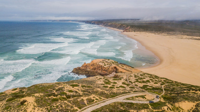 Aerial view of Bordeira beach, in Aljezur, Portugal. Beautiful beach surrounded by cliffs
