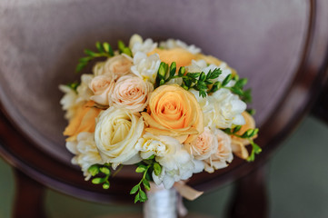 a bouquet of cream roses and white freesia