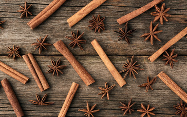 brown cinnamon sticks and dry star anise on a gray wooden background