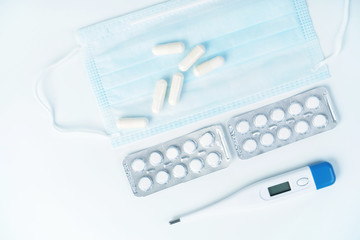 Medical digital thermometer and medical mask and pills. Medical concept