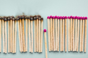 concept to stop the coronavirus COVID-19 from spreading -Matchsticks burn and one piece prevents fire from spreading, Social distance, Self-isolation or stay at home