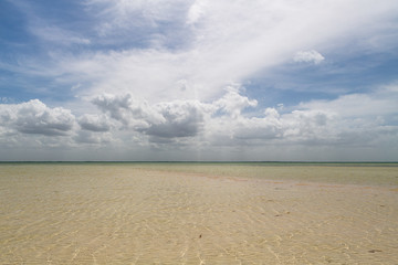 Beautiful crystal clear water beach with dramatic sky