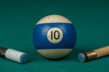 Billiards balls and cue on billiards table. Billiard sport concept.