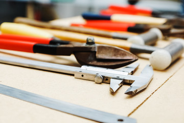 construction tools lie neatly on the table.  calipers