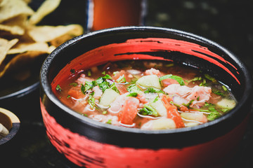 Bowl of ceviche made with raw fish cured with lemon and vegetables.