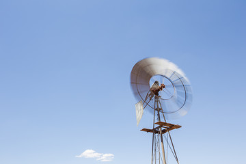 Wide amgle view of a lone windpomp / windmill on the plains of t