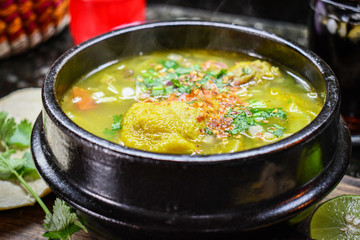 Leg chicken soup Mexican style with vegetables and dry chili.