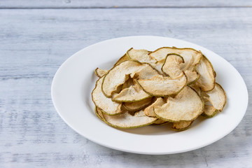 Dried  pear slices  on white plate. Healthy lifestyle.