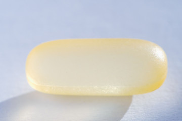 Pink capsule Pill tablet medicine lying isolated on white extreme close-up macro.