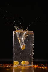 olive falling into clear liquid