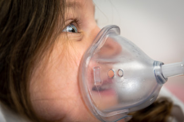cute little girl using a medical ventilator 