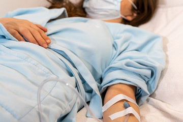 patient in hospital bed is receiving a medical perfusion