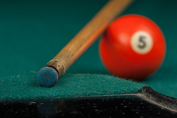 Billiards balls and cue on billiards table. Billiard sport concept.