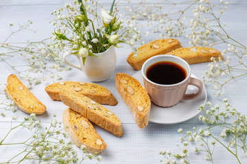 Italian tuscan traditional cookies cantuccini with almonds ,a cup of coffee on light background,top view