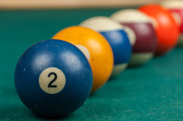 Billiards balls and cue on billiards table. Billiard sport concept.