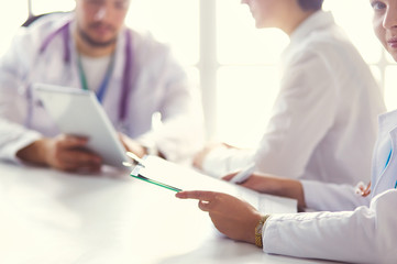 Fototapeta premium Serious medical team using a laptop in a bright office