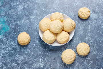 Various cookies in a wooden tray on gray background