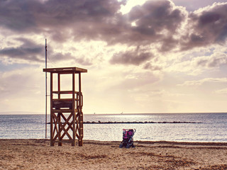 Baby carriage on waterfront near the sea