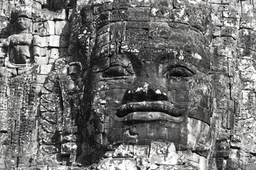 Monochrome or Black and White Image of Buddha Statue Head on Angkor Thom Gate to Angkor Wat, World...