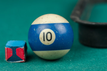 Billiards balls and cue on billiards table. Billiard sport concept.