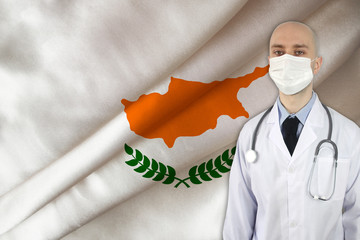 male doctor with a stethoscope on the background of the silk national flag of Cyprus. concept of...