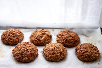 homemade baked oat cookies on white paper