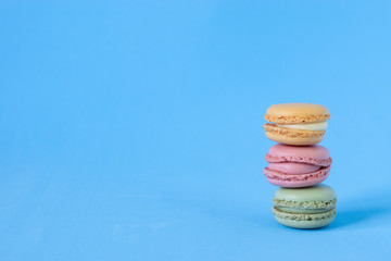 Brightly Colored Stacked Up French Macarons on Blue