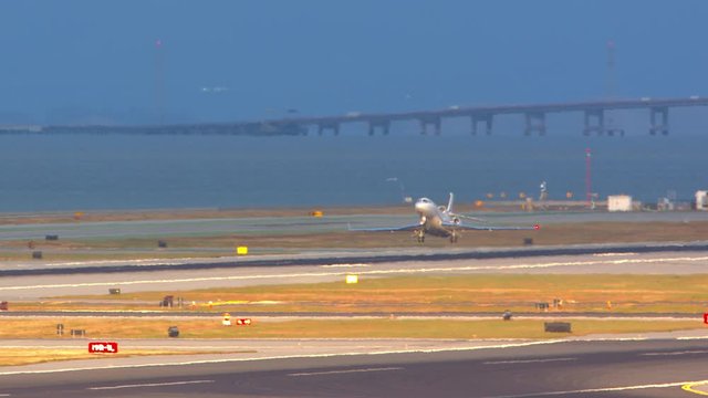 Generic Unmarked Executive Business Jet Airplane Taking off from Runway Departing near San Francisco Flying into a Sunny Golden Afternoon Sky in California
