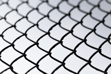 chain link fence against a bright sky