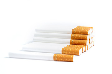 orange colored cigarettes with a gold ribbon on a white background. isolate