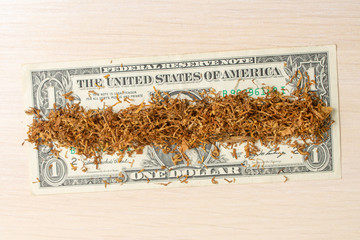 dollar with tobacco on a light tree