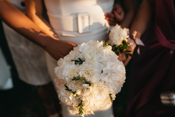 Beautiful bride in wedding dress with bouquet in hand