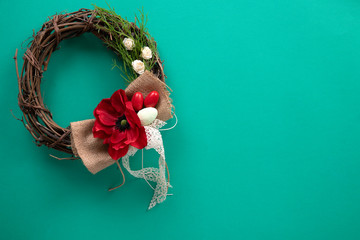 Decorative wreath on a turquoise paper
